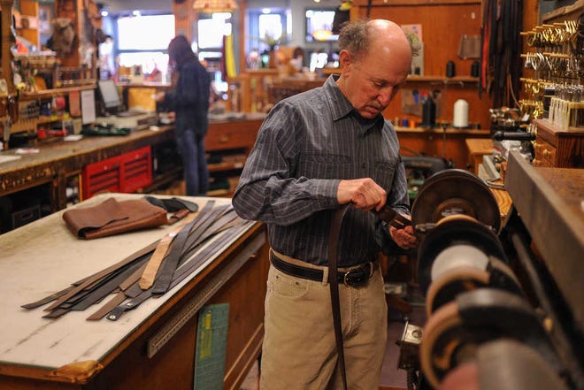 AJ Reynolds/Staff  Owner Irvin Alhadeff sands the end of a leather belt at Masada Leather & Outdoor. His downtown Athens shop is closing after 40 years.