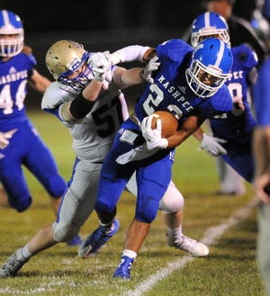 Devaun Ford of Mashpee is driven out of bounds by Chris Kennedy of St. John Paul II in Friday night's game at Mashpee won by the defending state champion Falcons. Ron Schloerb/Cape Cod Times