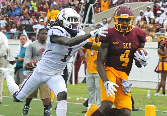 Bethune-Cookman's Jontavious Carter (4) scores a TD after making the reception from BCU QB Larry Brihm during MEAC/SWAC Challenge game on Sept. 4. News-Journal/NIGEL COOK