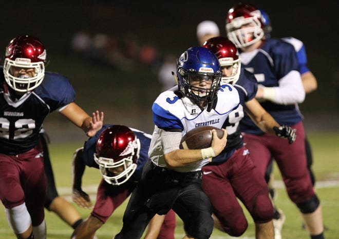 Cherryville quarterback Preston Elliott escapes the pocket against East Gaston Friday night. The Warriors defeated the Ironmen 29-19 in non-conference action. (Brian Mayhew / Special to the Gazette)