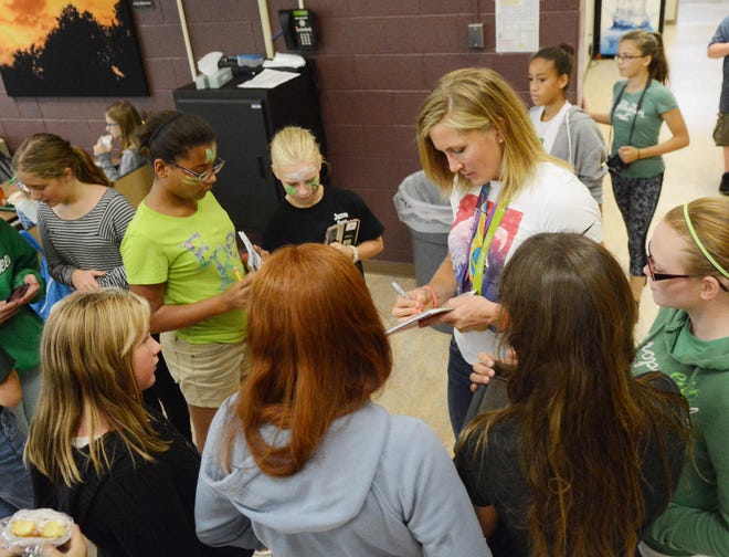 Jack Haley/Messenger Post Media

Olympic gold medal rower Meghan Musnicki, who went to Naples Central School until she was a junior, signs autographs for Naples students on Friday.