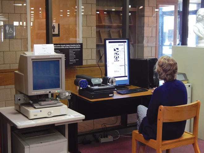 Reference librarian Meredith Sommers brings up a 1930s edition of the Sault News to show off Bayliss Library’s new digital microfilm viewer. The machine replaces the old viewer, left, and will allow the library to continue to support the vintage film strips.