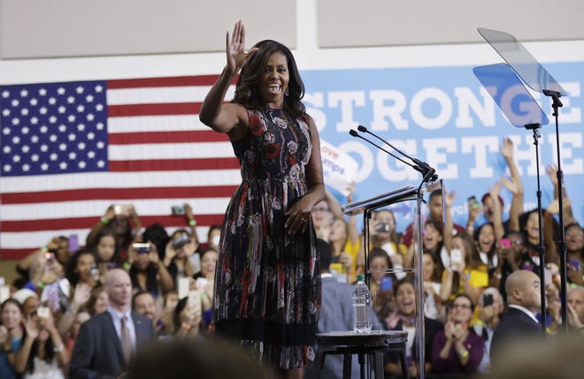 First lady Michelle Obama waves during a campaign rally in support of Democratic presidential candidate Hillary Clinton and vice presidential candidate Sen. Tim Kaine, D-Va., Friday at George Mason University in Fairfax, Va. (AP Photo/Manuel Balce Ceneta)