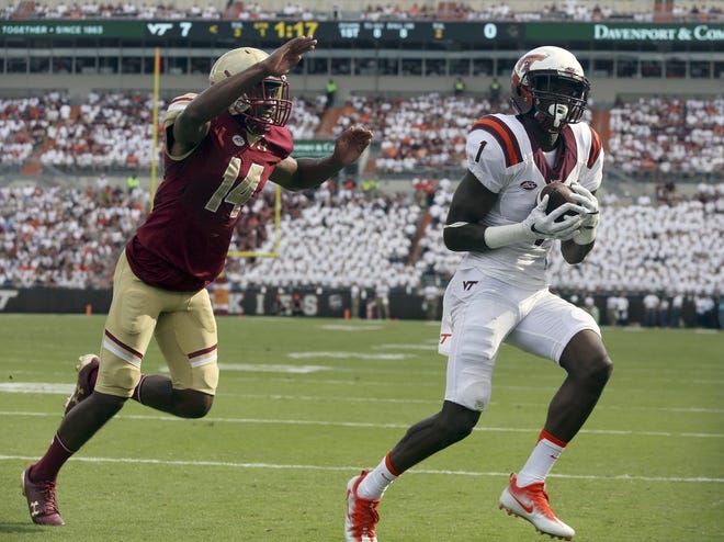Virginia Tech wide receiver Isaiah Ford (1) catches a touchdown pass in front of Boston College's Tavante Beckett in the first quarter of Saturday's game in Blacksburg Va. Matt Gentry/The Roanoke Times via AP