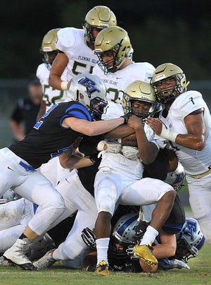 Bruce.Lipsky@jacksonville.com -- 09/16/16 -- Fleming Island's Anfernee McCaskill (21) is gang tackled in the first quarter. Fleming Island visited Bartram Trail in the District 3-7A opener Friday, September 15, 2016, in St. Johns, Florida. (Florida Times-Union, Bruce Lipsky)