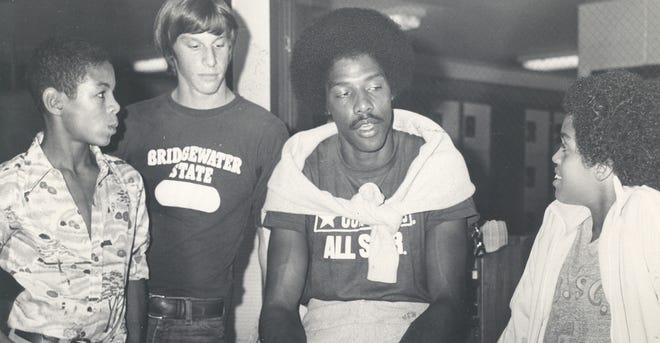 While visiting New Bedford in September 1976, Julius Erving takes a moment to talk with, from left, Leroy Young, Todd DosReis and Charles Garland. STANDARD-TIMES FILE PHOTO/SCMG