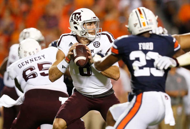 Texas A&M quarterback Trevor Knight, center, sets back to pass the ball against Auburn in the first half during an NCAA college football game, Saturday, Sept. 17, 2016, in Auburn, Ala. (AP Photo/Brynn Anderson)