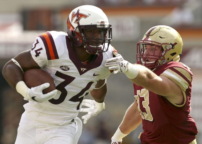 Travon McMillian (left) and the Virginia Tech offense gashed Connor Strachan and the Boston College defense for 254 rushing yards in the Hokies' 49-0 win over the Eagles on Saturday.
