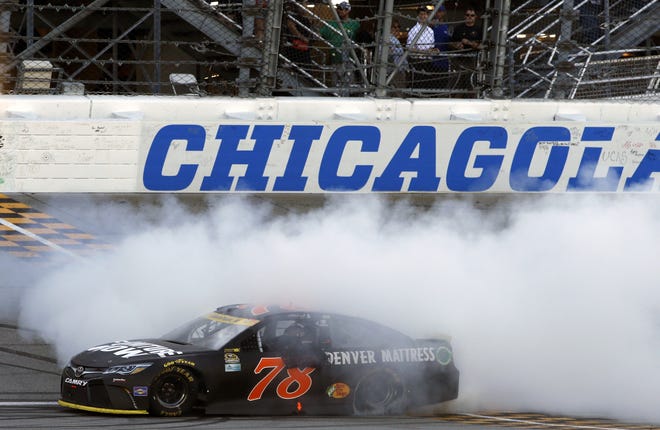 Martin Truex Jr. celebrates after winning the NASCAR Sprint Cup Series race at Chicagoland Speedway on Sunday. (AP Photo/Nam Y. Huh)