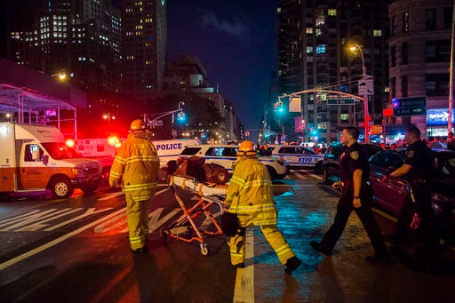 Police and firefighters work near the scene of an apparent explosion in Manhattan's Chelsea neighborhood, in New York, Saturday night.