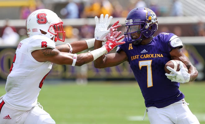 East Carolina's Zay Jones, right, fights off a North Carolina State defender during the Pirates 33-30 win on Sept. 10. Jones had a career day on Saturday against South Carolina, hauling in 22 catches for 190 yards, but ECU lost 20-15 to the Gamecocks. Rhett Butler/The Daily Reflector