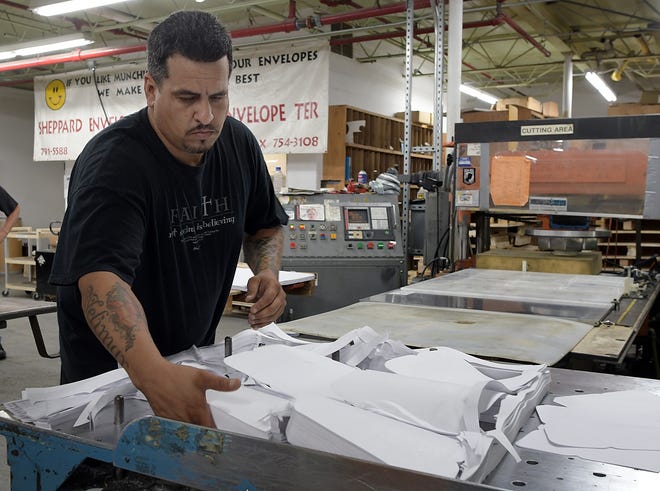 Julio Rodriguez operates a cutting machine at Sheppard Envelope Company in Auburn. T&G Staff/Rick Cinclair