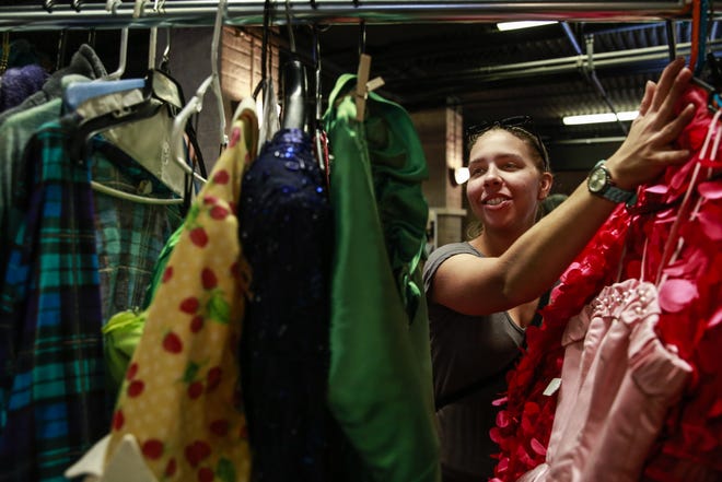 Kaytlyn Blain, 26, looks through costumes during the Hipp Costume Sale Extravaganza at the Hippodrome Theatre on Saturday. "I'm looking for any gems that I can find," Blain said. (Andrea Cornejo/ Correspondent)