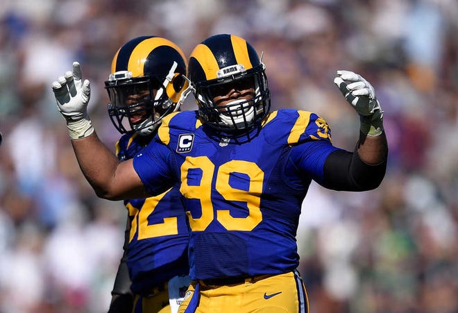 Los Angeles Rams defensive tackle Aaron Donald tries to fire up the crowd during the second half of an NFL football game against the Seattle Seahawks at the Los Angeles Memorial Coliseum, Sunday, Sept. 18, 2016, in Los Angeles. (AP Photo/Kelvin Kuo)