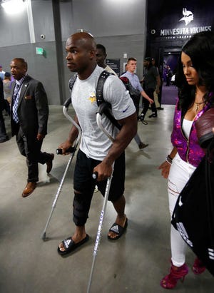 Minnesota Vikings running back Adrian Peterson leaves U.S. Bank Stadium on crutches after playing the Green Bay Packers on Sunday in Minneapolis. The Vikings won 17-14.