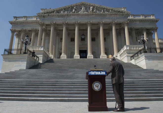 In this Spet. 8 photo, Senate Minority Leader Harry Reid of Nevada waits on the House steps of the U.S. Capitol in Washington for a rally. (AP Photo/Molly Riley)