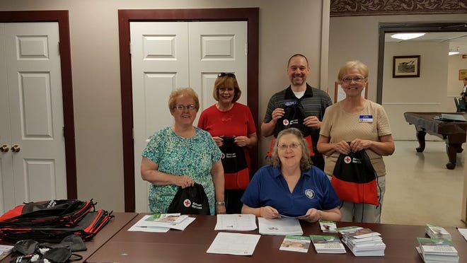 This photo shows some of the RSVP staff and volunteers who assembled disaster kits this summer. From left to right: Bonnie Clukey, Judy Sharpe, Josh Fields (who was then Volunteer Coordinator), Cathy Wagel on the right and Barb Basye seated in the middle. (Courtesy photo)