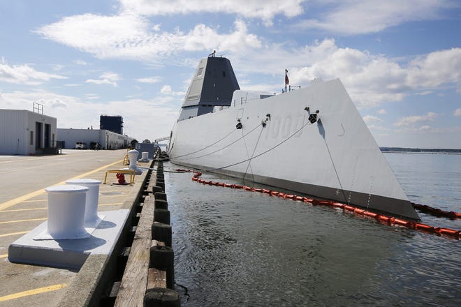 The USS Zumwalt sits at dock at the naval station in Newport, R.I., Friday, Sept. 9, 2016. The 610-foot-long warship has an angular shape to minimize its radar signature and cost more than $4.4 billion. It will be in Virginia at Naval Station Norfolk longer than expected after crew members detected a leak on the vessel.
