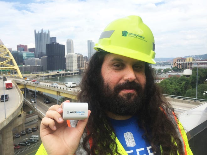 In this Sept. 8, 2016, photo provided by Waze, Waze system operation engineer Gil Disatnik holds a Waze beacon in Pittsburgh, where the beacons have been installed in two tunnels. The popular navigation app Waze is putting a new twist on the phrase “tunnel vision.” It’s trying to ensure that drivers relying on digital maps don’t lose their way when their GPS signal disappears in tunnels. (Meghan Kelleher/Courtesy of Waze via AP)