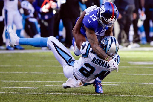 FILE - In this Dec. 20, 2015, file photo, New York Giants wide receiver Odell Beckham (13) and Carolina Panthers' Josh Norman (24) grapple during the first half of an NFL football game in East Rutherford, N.J. Whether the receiver and Norman, now a Redskins cornerback, can play nice on the field Sunday when Washington comes to MetLife Stadium for an NFC East rivalry game remains to be seen. (AP Photo/Julie Jacobson, File)