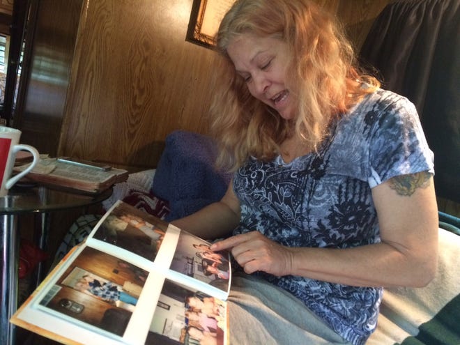 Gabrielle Crothers, the mother of defendant Matthew Crothers and victim David Crothers, looks through a family photo album at pictures of her children at younger ages.(Andrew Scott/Pocono Record)
