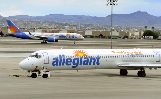Two Allegiant Air jets taxi at McCarran International Airport in Las Vegas. (AP Photo/David Becker,File)