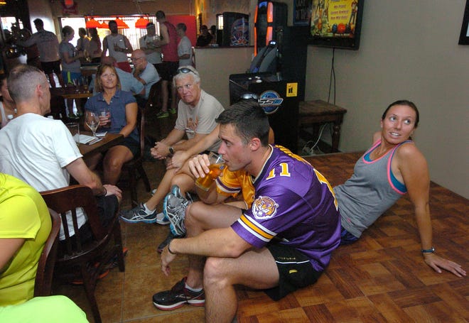 Robert Wright hydrates after the run. After completing the weekly Hump Day 5K most runners usually enjoy a beer and socialize inside Mr. Beery's. HERALD-TRIBUNE ARCHIVE