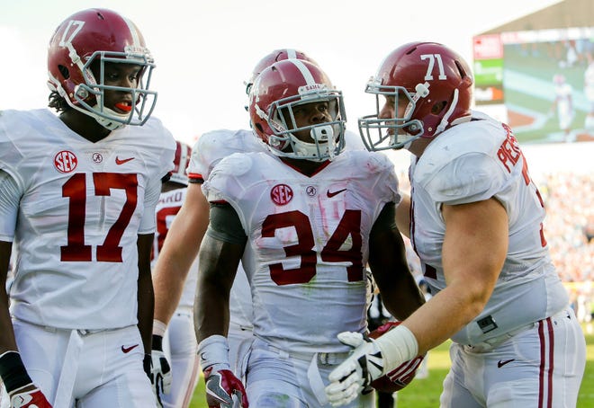 Alabama wide receiver Cam Sims (17), Alabama running back Damien Harris (34) and Alabama offensive lineman Ross Pierschbacher (71) celebrate Harris's long run during Alabama's 48-43 win over Ole Miss in Oxford Saturday, September 17, 2016. Staff Photo/Gary Cosby Jr.