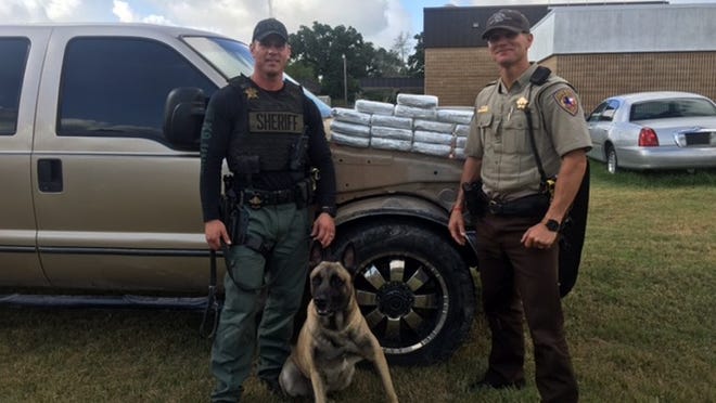 Fayette County sheriff’s office deputies Randy Thumann, Lobos and David Smith pose with contraband seized Monday. Photo provided by Fayette County sheriff’s office.