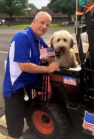 (File) Patrick Miller, chairman of the Southampton Days Committee for the past 11 years, is pictured with his dog, Duncan. Southampton residents have planned a banquet to honor Miller, who died last week.