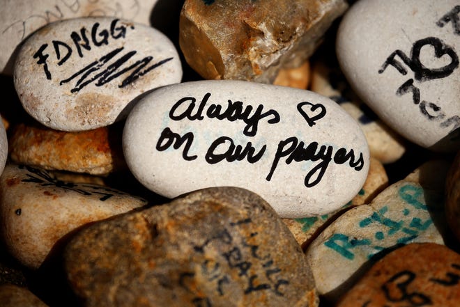 Rocks are printed with words of encouragement outside the Pulse night club following the shootings earlier this year in Orlando, Sept. 17, 2016. REUTERS/Carlo Allegri