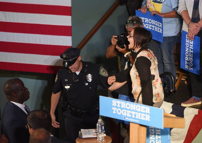 Lisa Demaine, a University of New Hampshire senior and Epping native, is escorted out of Sen. Tim Kaine's Exeter Town Hall rally last week after trying to question the candidate about the Dakota Access Pipeline. Deb Cram/Seacoastonline