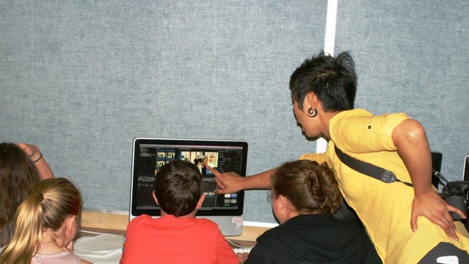 (Right to left) Film class teacher Jo Huang talks to students Mikael Scerry, Andrew Ramon and Taylor Tippit about using Final Cut Pro at St. Austin Catholic School. The students are participating in a screenwriting and filmmaking camp, which Westlake High School will also host at the end of this month. KATIE URBASZEWSKI/WESTLAKE PICAYUNE7-8-15
