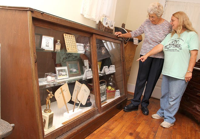 Rosemary Chapman, with the Litchfield Historical Society (left) and Betty Todd, with the Allen Historical Society talk about items on display at the Hillsdale County Historical Society Museum at the fairgrounds. ANDY BARRAND PHOTO