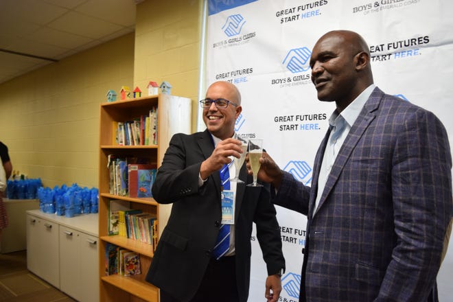 Boys and Girls Club of the Emerald Coast CEO Shervin Rassa toasts with Boys and Girls Club spokesman Evander Holyfield at the club's third annual Steak and Stake fundraiser Thursday night in Santa Rosa Beach. ANNIE BLANKS/The Log