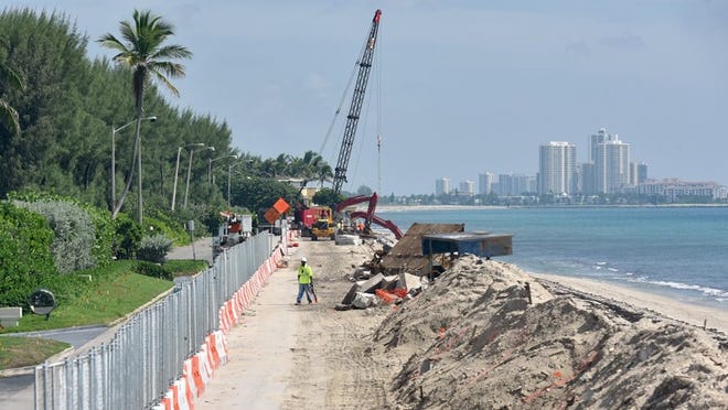 Construction continues Tuesday on the sea wall along North Ocean Boulevard across from the Palm Beach Country Club.