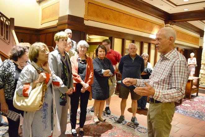 Artist Gary Ernest Smith, right, conducts a tour of his works on display at the Hotel Pattee Thursday.