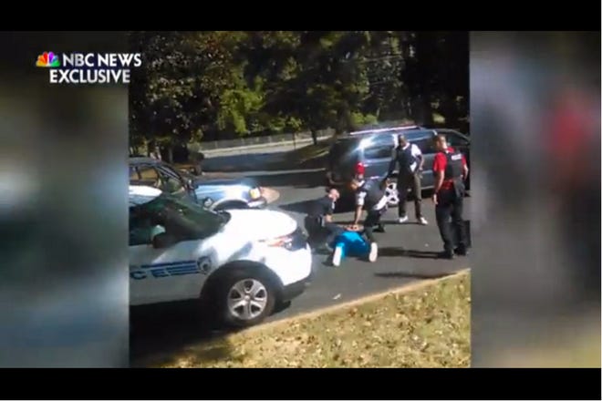 Video of a deadly encounter between Charlotte police and a black man shows his wife repeatedly telling officers he is not armed and pleading with them not to shoot as they shout commands to drop a gun. (NBC News)