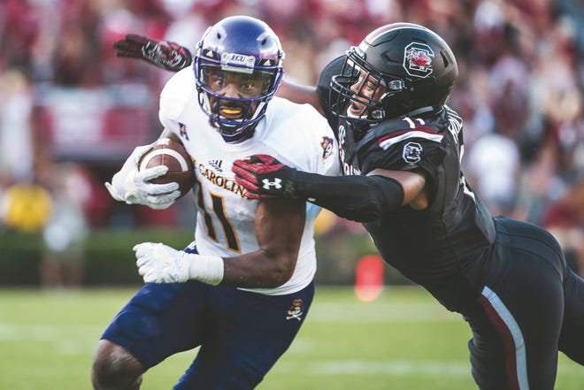 East Carolina wide receiver James Summers (11) attempts to escape a tackle by South Carolina linebacker T.J. Holloman during the second half of an NCAA college football game Saturday in Columbia, S.C. East Carolina plays at Virginia Tech on Saturday.