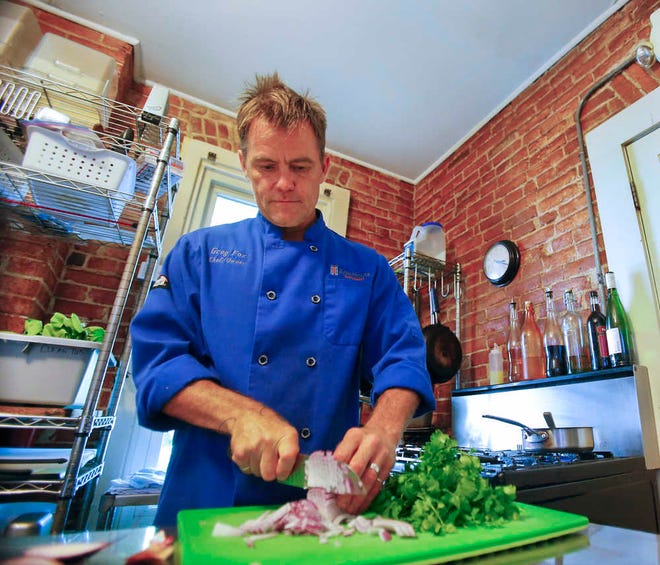Greg Fox, chef and owner of RowHouse Restaurant, prepares vegetables for one of his special dinners.