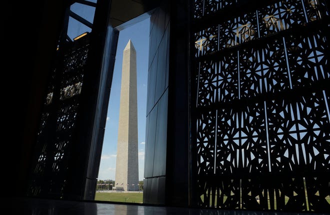 The Washington Monument is framed by a window at the National Museum of African American History and Culture in Washington, Wednesday, Sept. 14, 2016. (AP Photo/Susan Walsh)