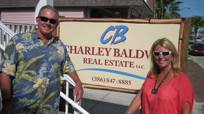 Charley Baldwin, left, a third generation New Smyrna Beach resident and former surfing champion, and partner Rhonda Kanan opened Charley Baldwin Real Estate in May along Flagler Avenue in New Smyrna Beach. NEWS-JOURNAL/BOB KOSLOW