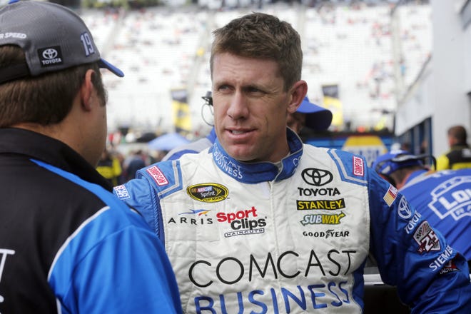 Carl Edwards talks with his crew after the final practice for Sunday's NASCAR Sprint Cup Series auto race at New Hampshire Motor Speedway Saturday, Sept. 24, 2016, in Loudon, N.H. (AP Photo/Jim Cole)