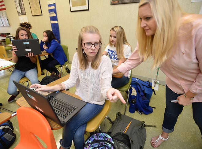 Haley Dowis, 17, center, works with history and psychology teacher Lana Greene, right, in her first class of the day at Broome High School. Dowis said she tries to go to bed early, but often ends up lying there awake and doesn't get enough sleep. ALEX HICKS JR/alex.hicks@shj.com