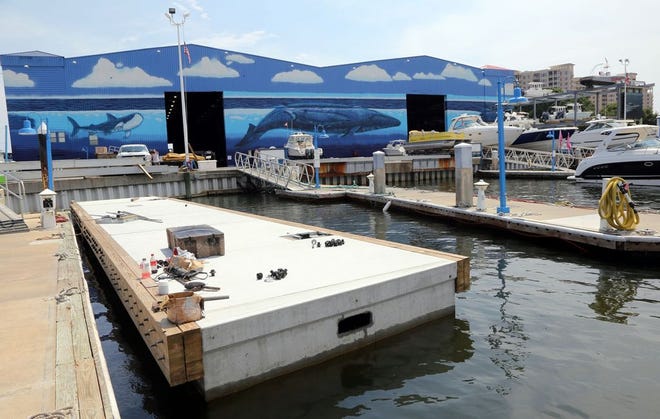 Part of a new dock floats alonside the existing one as construction on new docks continues at Legendary Marine in Destin. FILE PHOTO/The Log