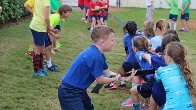 Rosarian Academy third graders compete in tug of war on the lower school’s field day.