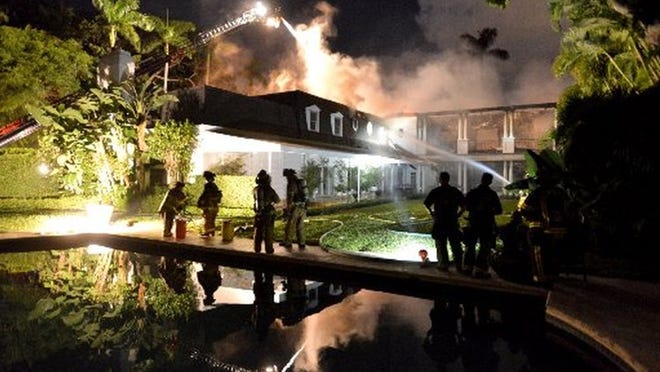 Firefighters from Palm Beach Fire-Rescue and Palm Beach County Fire Rescue work to control a fire at 417 Primevera Ave. in November.