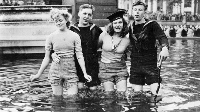 The war in Europe was finally over, and two British sailors and their girlfriends celebrated by wading into the Trafalgar Square fountain pool. Courtesy the London Imperial War Museum