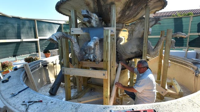 Richard Naylor, a mason from Premier Stoneworks, builds traveling supports Feb. 13 around the four hippocamps that support the bowl of the Memorial Fountain in preparation for transport to Clifford Restoration in Ontario, Canada.