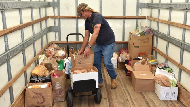 Chris Hoyt of the Palm Beach County Food Bank loads a portion of the donations from the Empty Your Pantry Food Drive.